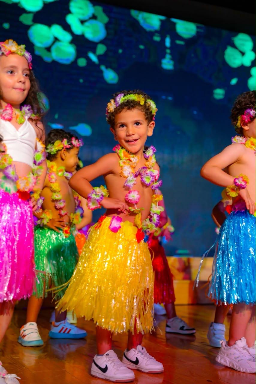 Andy Pandy graduates performing a tropical Hawaiian dance on stage — Class of 2026